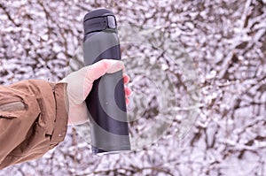 Vacuum insulated mugs in left hand. Drink coffee in the winter.