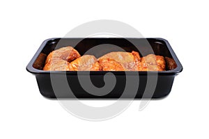 Vacuum packaging.Fresh, raw chicken thigh in the package.Chicken legs in red marinade in plastic packaging for supermarkets.