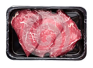 Vacuum-packed beef on a white background.