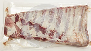 Vacuum packed fresh pork ribs meat isolated on white