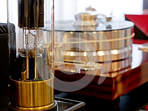 Vacuum tube amplifier in the foreground and Audiophile HiFi turntable