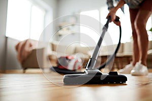 Vacuuming floor at home photo