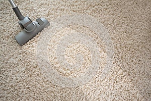 Vacuuming rough carpet with vacuum cleaner