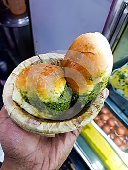 Vada pau bread and green sauce and green chili on a plate