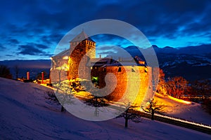 Illuminated castle of Vaduz, Liechtenstein at sunset - popular landmark at night