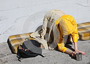 Vagabond Asks for alms in the city street