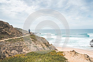 Vagabund moves along the mountainside at Alteirinhos Beach near Zambujeira do Mar, Odemira region, western Portugal. Wandering photo