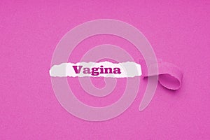 Vagina word revealed underneath torn pink paper photo