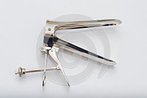 Vaginal speculum on white surface photo