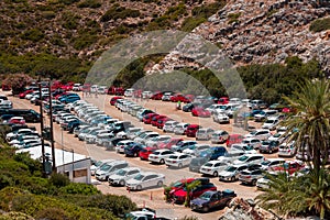 VAI, CRETE - 15 JULY 2021: Large numbers of similary coloured rental cars parked at Vai beach in Eastern Crete Greece