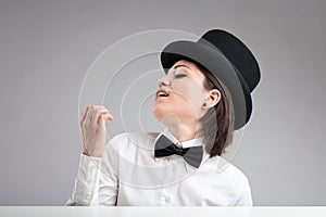 Vain woman in top hat showing herself off