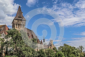 Vajdahunyad Castle peeks out from behind the summer foliage