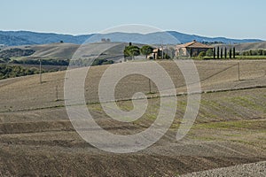 VAL D`ORCIA, TUSCANY-ITALY, OCTOBER 30, 2016:Classic view of scenic Tuscany landscape with famous farmhouse amidst idyllic hills