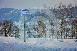 Valdres, Norway - March 26, 2018: Outdoor view of sign of bus stop at one side during winter in the road