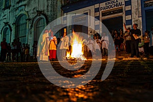 Catholic priest is celebrating night mass around the holy bonfire on hallelujah saturday night. Holy week in Valenca, Bahia