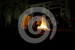 A priest is seen celebrating night mass around the Santa bonfire on Saturday night of Hallelujah. Holy week in Valenca, Bahia