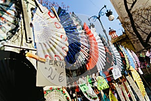 Valencia, Spain - February 24, 2019: Typical colorful Spanish flamenco fans for sale in a street market in spring