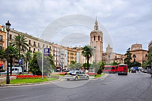 Valencia, Spain - 30 June 2018: Valencia Cathedral and Torre del Miguelete tower on Plaza de la Reina (Queen's square