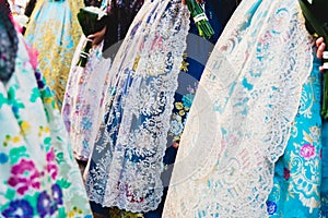 Valencia, Spain - March 17, 2019: Detail of the typical fallero dress, during the colorful and traditional parade of the offering