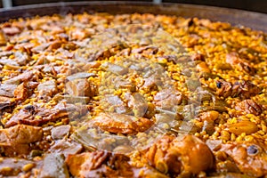 Valencian paella made of rice, chicken, rabbit and vegetables. Close up shot.