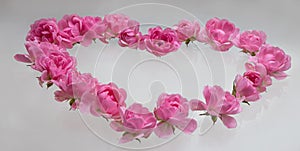 Valentine background. Heart shaped bouquet of beautiful pink rose flowers