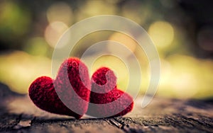 Valentine background with red hearts placed on wooden floors and blurring of nature as background.