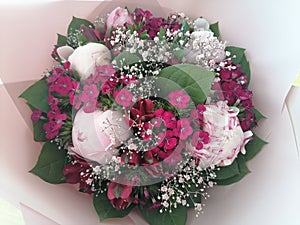 Valentine, Beautiful pink bouquet with peonies flowers, blossoms from above wraped in pink paper