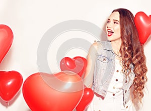 Valentine Beauty girl with red air balloons laughing, on white background. Beautiful Happy Young woman. Womans day. Holiday party.