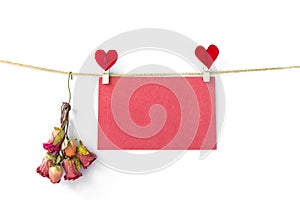 Valentine card background idea, blank red paper card with red heart clip and blurred red rose paper flower isolate on white backgr