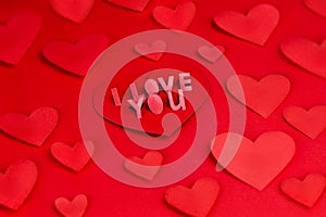 Valentine card with lettering I Love You. Declaration of love. Love letter, Red paper craft hearts red background, texture