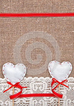 Valentine card with textile hearts and lacy cloth