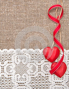 Valentine card with wooden hearts and lacy cloth