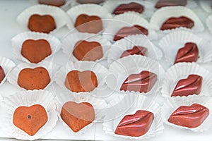 Valentine chocolate confectionary and bakery glass display of handmade individual truffles in then shape of lips and
