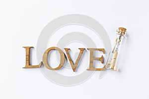 Valentine concept background, love wooden font with message in glass bottle on white background