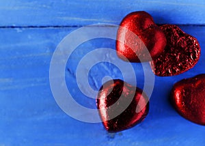 Valentine concept with red heart chocolate on blue wooden backgrounds