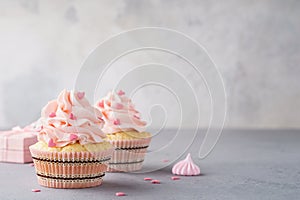 Valentine cupcakes decorated with sweet hearts and a gift box photo
