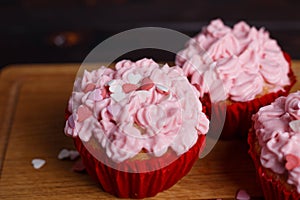 Valentine cupcakes with pink cream and sugar heart decorations.