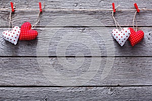 Valentine day background, pillow hearts border on wood, copy space