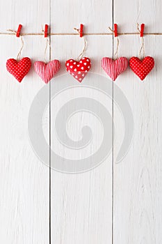 Valentine day background, pillow hearts border on wood, copy space