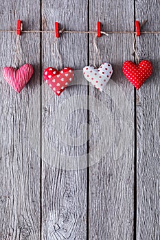 Valentine day background, pillow hearts border on wood, copy space