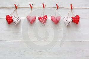 Valentine day background, pillow hearts border on wood, copy space