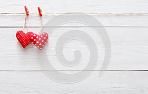 Valentine day background, pillow hearts border on wood, copy space