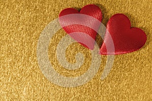 Valentine day background with two red hearts on shiny golden background