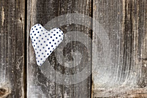 Valentine day, blue dotted handmade heart on grey wood background.Valentine`s Day card