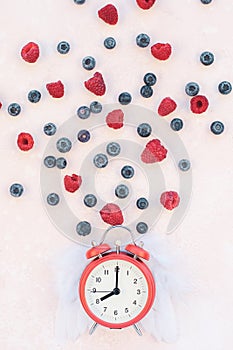 Valentine Day composition berries alarm clock