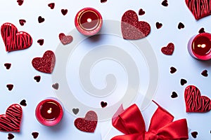 Valentine day composition: red love hearts, romantic gift box, candle on white background. February romance present card. Top View