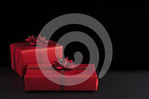 Valentine day concept. Red Christmas gift boxes on black background. Greeeting card, postcard