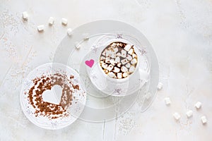 Valentine day decoration, breakfast, white vintage cup and plate, coffee with small marshmallows and hearts made from red paper