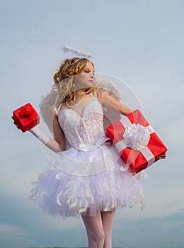Valentine Day Gift Card - Holiday teen Cupid angel with gift with Love. Innocent Girl with angel wings standing with bow