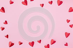 Valentine day greeting card or banner. Paper red hearts frame on pink background